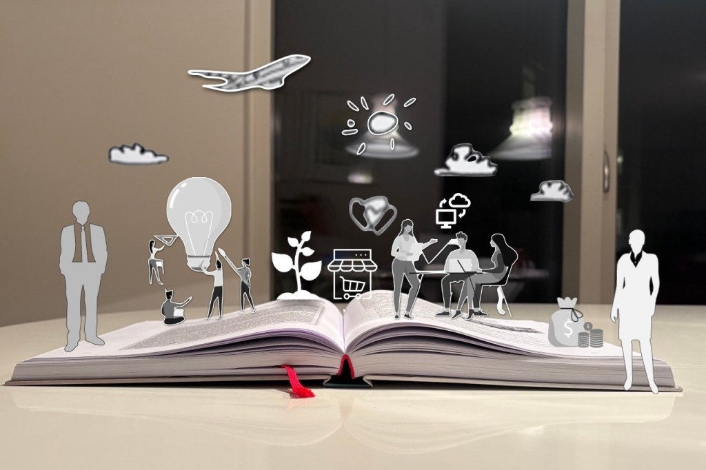 Otvorena knjiga Preduzetništvo, crtezi i sličice koji izlaze iz knjige kao teme